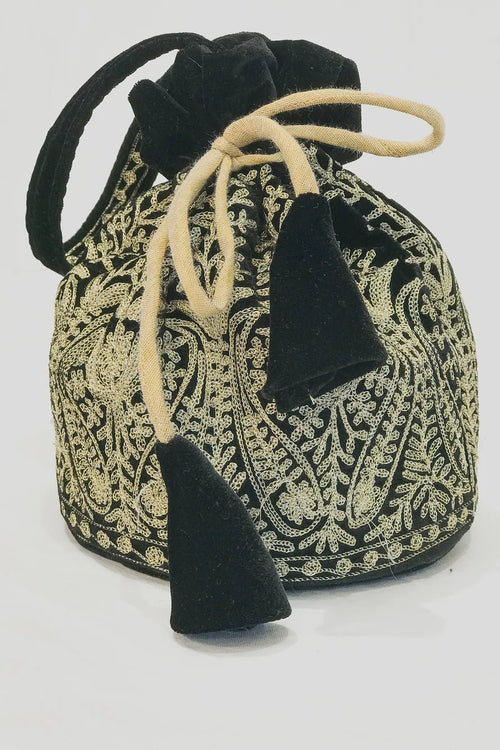 Black and gold patterned drawstring bag with tassels on a white background