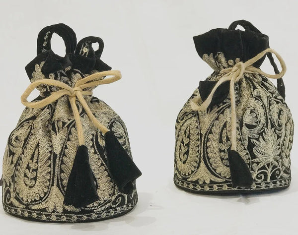 #Black Two black and gold patterned drawstring bags on a white background
