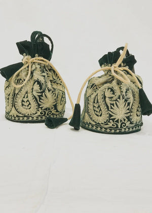 #BottleGreen Two decorative bags with intricate green and gold patterns on a white background