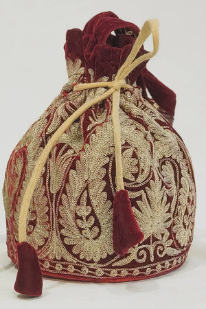 #Maroon Decorative drawstring bag with intricate patterns on a white background