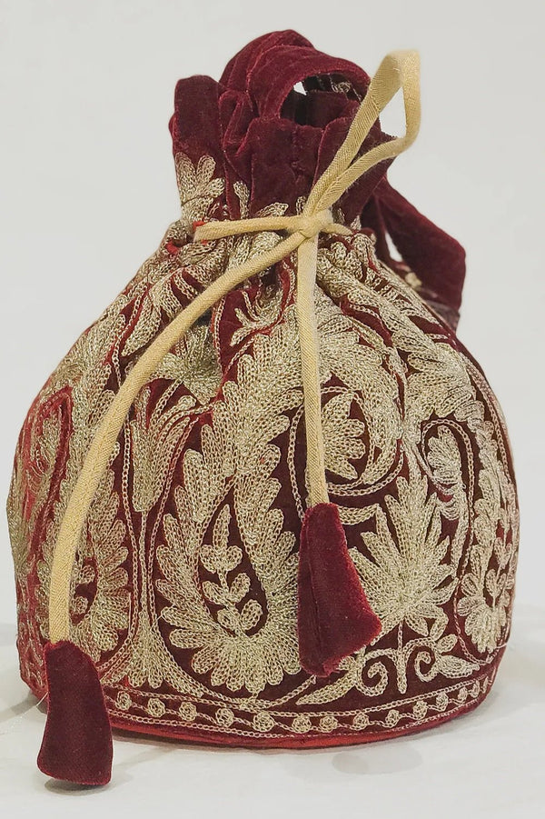 #Maroon Decorative drawstring bag with intricate patterns on a white background