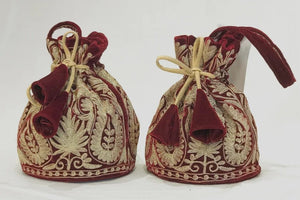 #Maroon Two embroidered fabric bags with red and gold patterns on a white background