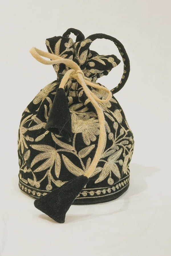 #Black drawstring bag with gold floral patterns on a white background