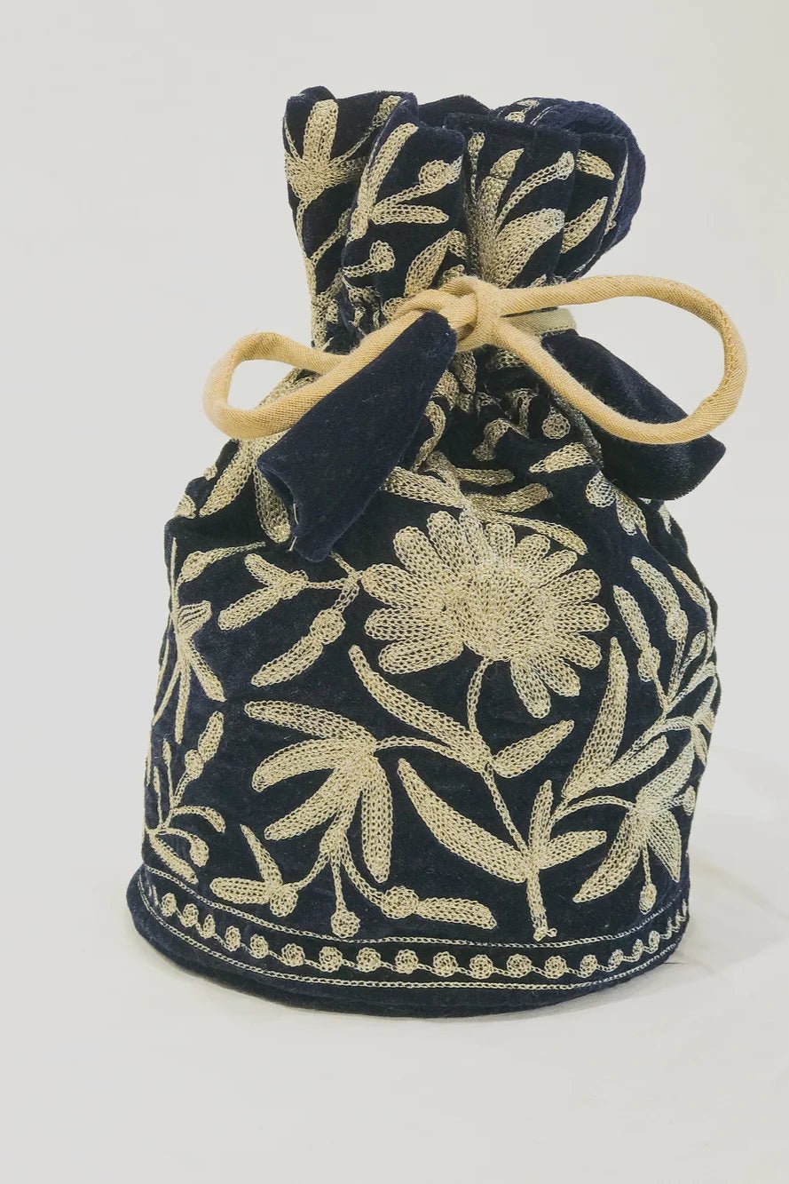 #BottleGreen Green fabric drawstring bag with gold floral patterns on a white background