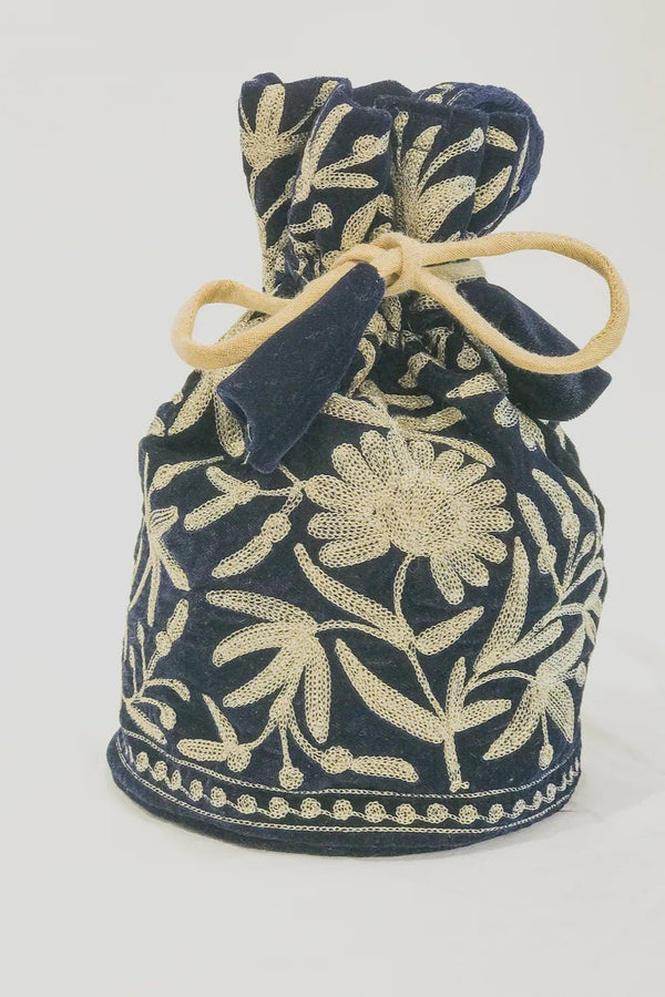 #NavyBlue Navy blue drawstring bag with beige floral patterns on a white background
