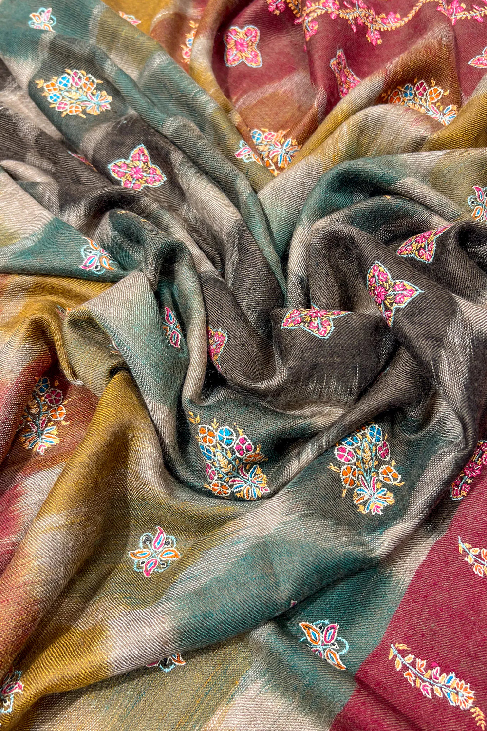 Colorful patterned fabric with geometric shapes and floral designs.