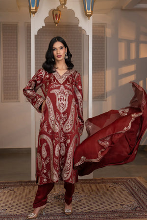 #CrimsonMaroon - Front view of wine kurta with dense dull-gold paisley embroidery, gathered sleeves, and matching salwar; dupatta draped over arms
