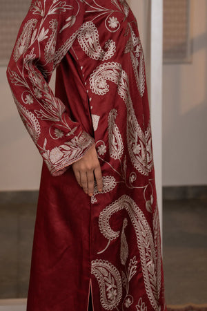 #CrimsonMaroon - Close-up side view of wine linen satin kurta showing large paisley kalka motifs and floral vine embroidery in dull gold
