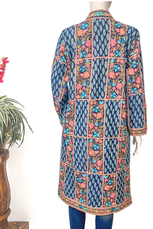 Traditional embroidered kurta on a mannequin against a white background
