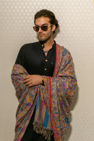 Detail of tight Kani weave showing red, gold, green and blue floral motifs on natural beige Pashmina