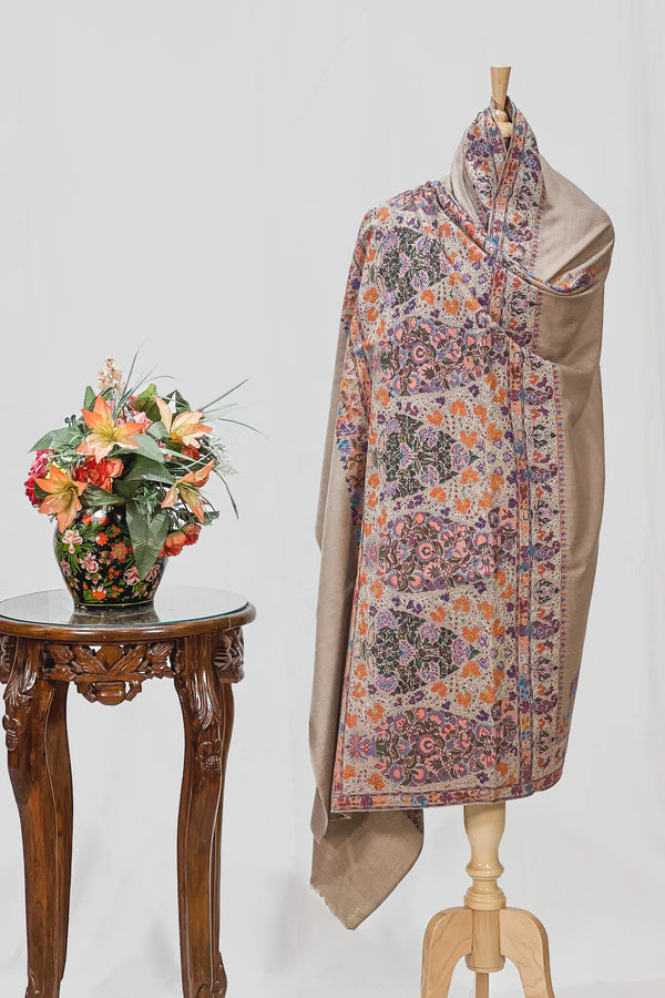 Detail of multi-colour hand embroidery stitched over painted kalamkari imagery on Pashmina