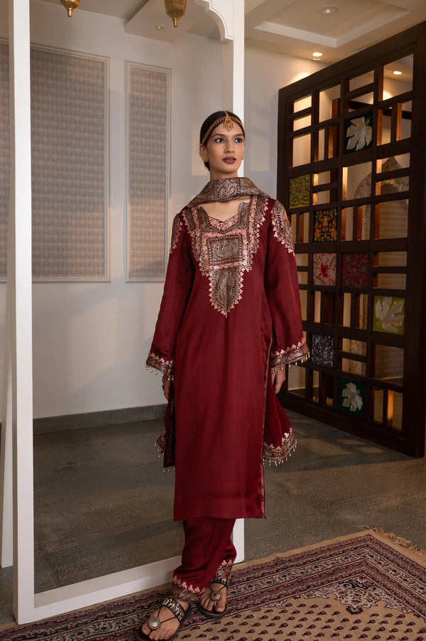 #Maroon - Three-quarter front view of maroon kurta with zari yoke embroidery, embroidered shoulder extension, and tassel-edged cuffs