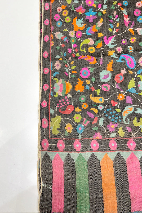 Colorful woven fabric with floral patterns on a plain background