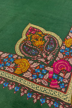 Colorful embroidered design on a green fabric background