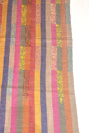 Multicolored striped fabric with patterned patches on a white background