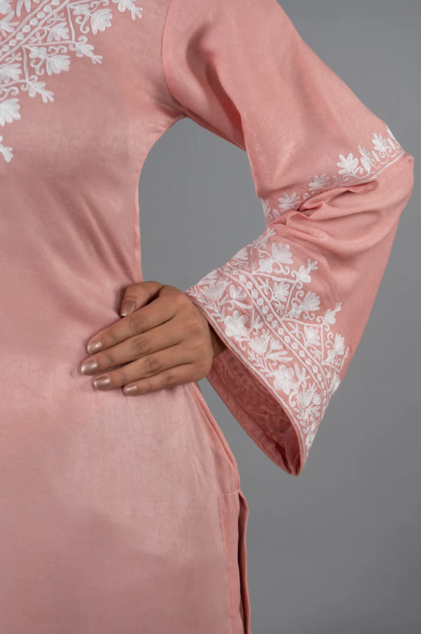 #BlushPink Pink outfit with white embroidery on sleeves against a gray background