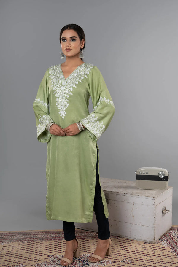 #MossGreen Woman wearing a green embroidered kurta with black pants against a gray background