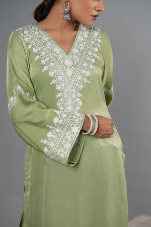 #MossGreen Green dress with white embroidery on a gray background