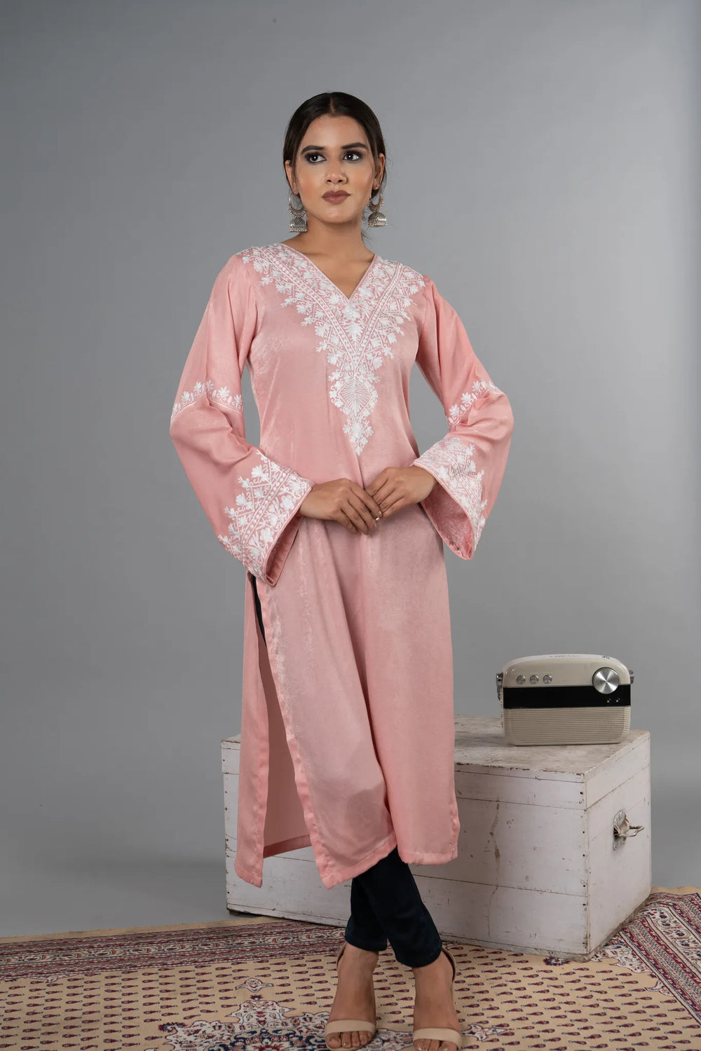 #BlushPink Woman wearing a pink embroidered dress with a gray background