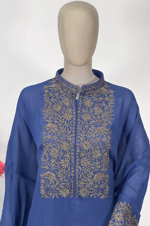 #Blue - Front close-up of periwinkle blue Chinon kurta on mannequin; dense gold floral vine on chest yoke and mandarin collar