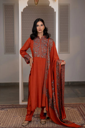 #Rust - Full-length front view of rust Chinon suit set; dupatta with embroidered border held at side; salwar and jutti visible