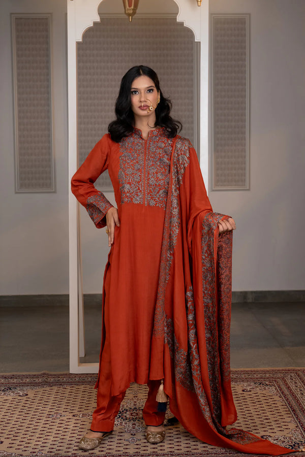 #Rust - Full-length front view of rust Chinon suit set; dupatta with embroidered border held at side; salwar and jutti visible