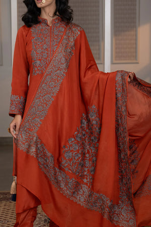 #Rust - Model holding embroidered Chinon dupatta wide; rust kurta shows full chest yoke and cuff embroidery clearly