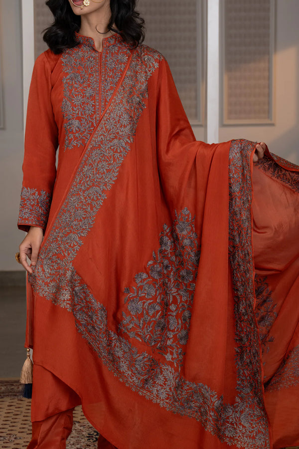 #Rust - Model holding embroidered Chinon dupatta wide; rust kurta shows full chest yoke and cuff embroidery clearly
