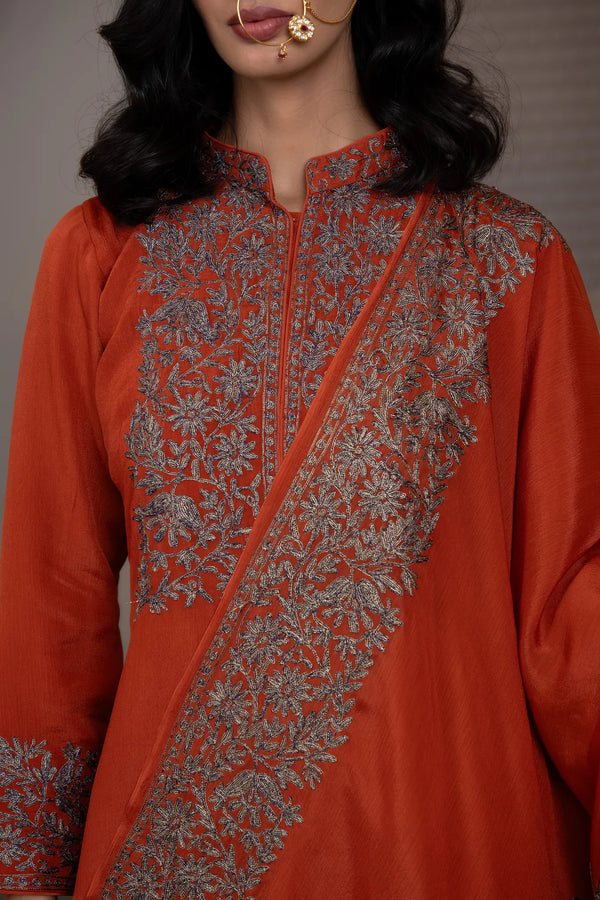 #Rust - Detailed neck close-up of rust Chinon kurta; mandarin collar with zip placket; dense gold and navy floral vine on yoke