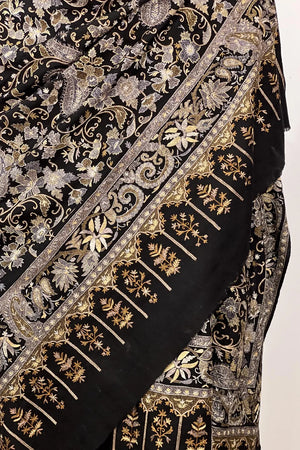Close view of tilla jaal lattice on black pashmina — dull gold and silver threads interlocking across the surface