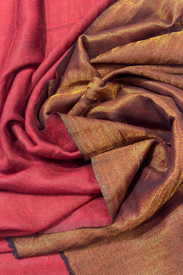 #Maroon - Maroon and gold zari pure wool stole gathered in a spiral, showing the depth and drape of the reversible fabric