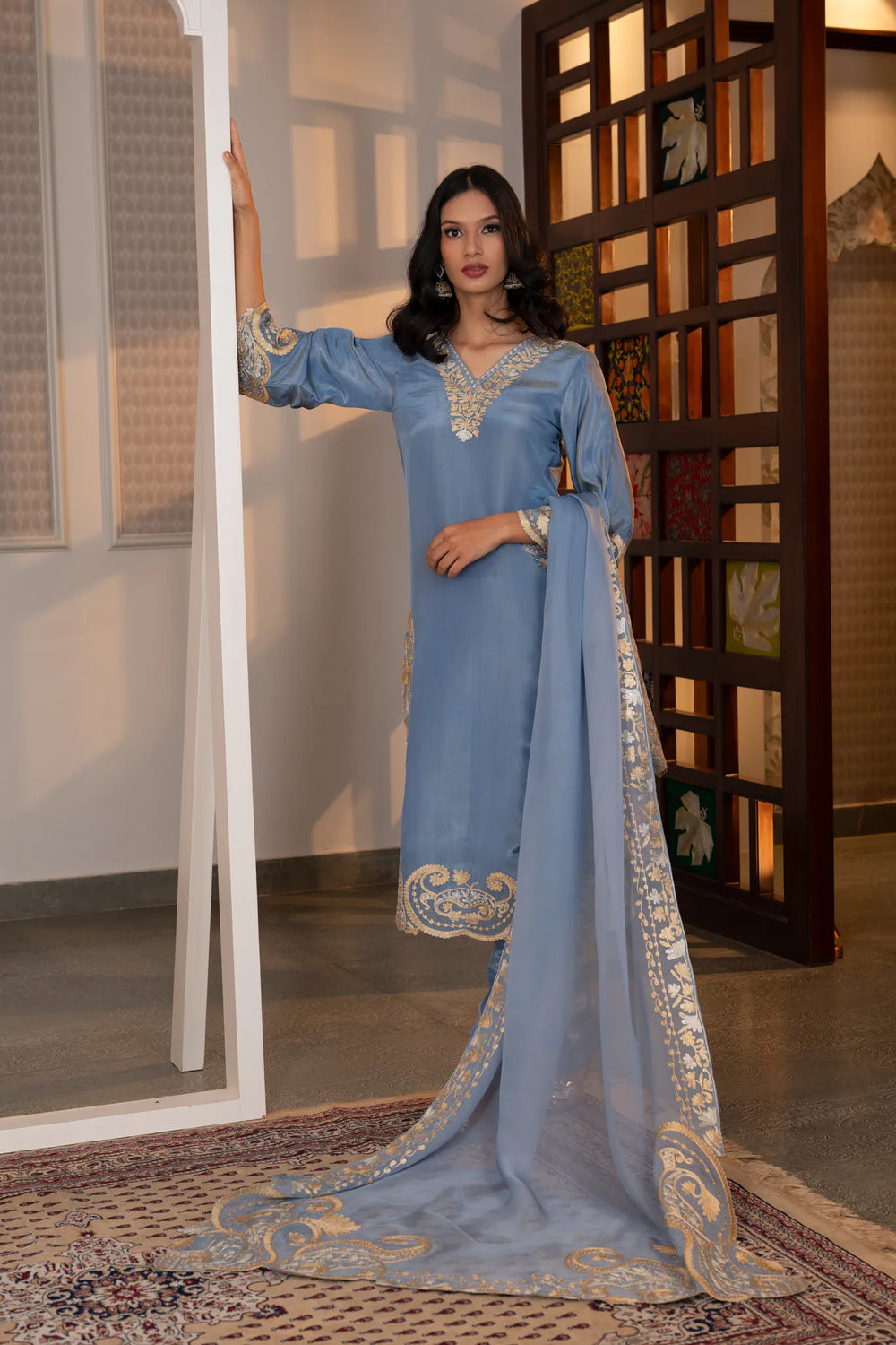 Sky blue tissue kurta suit set with gold and silver zari Kashmiri embroidery, organza dupatta, straight pants, front view.