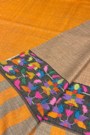 Textile with colorful butterfly pattern on a brown and orange background