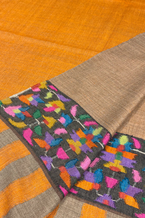 Textile with colorful butterfly pattern on a brown and orange background