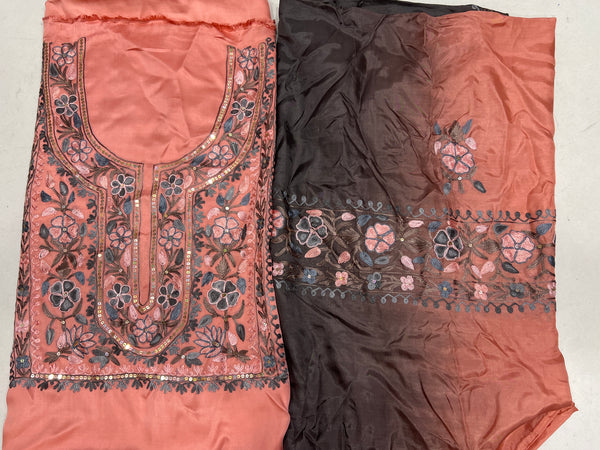 #Peach Two pieces of fabric, one with a floral Aari and sequence work in the center and the other with a border featuring the same style of work.