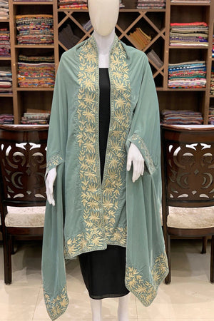 #MintGreen Mannequin wearing a green embroidered shawl in a fabric store.