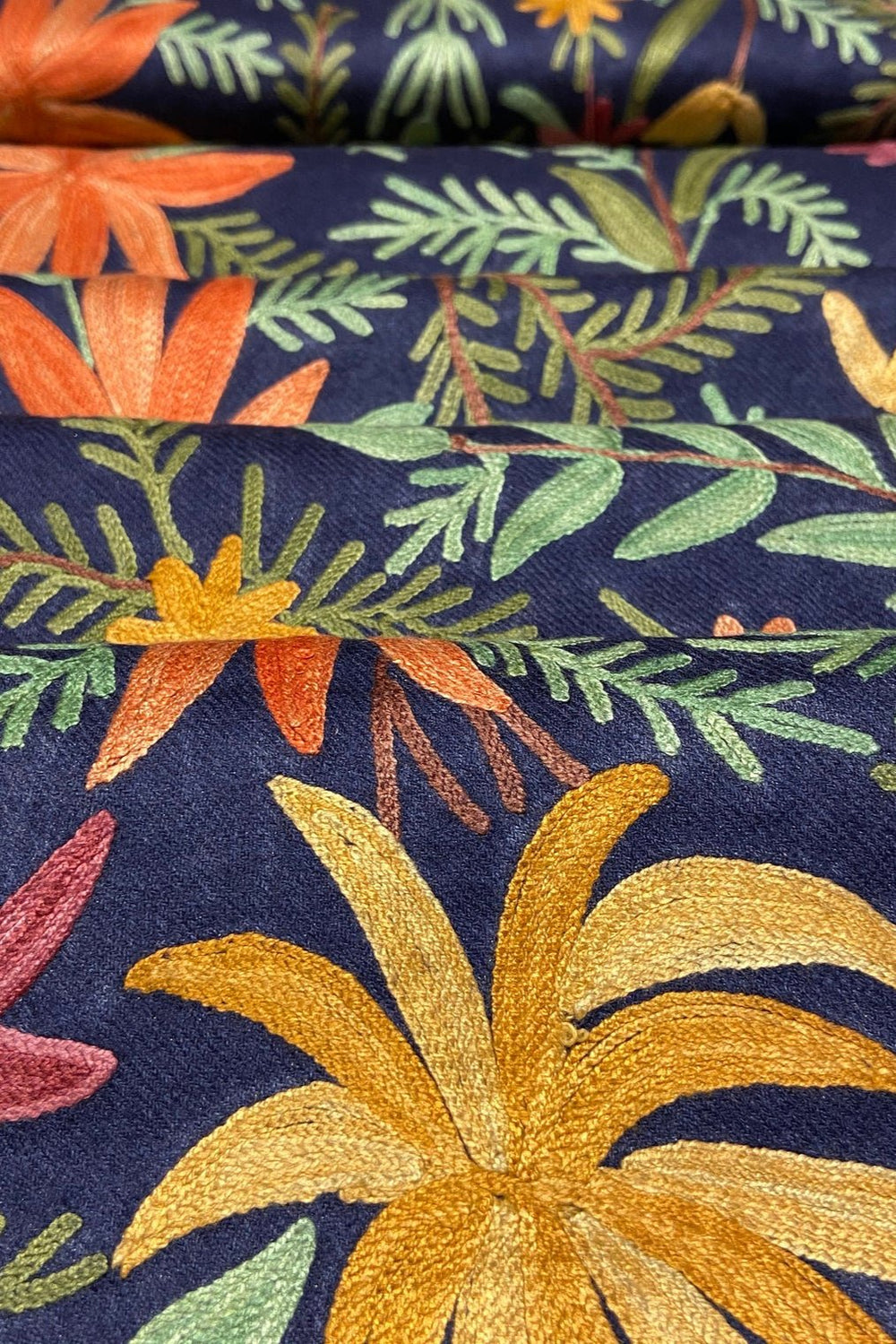 Floral fabric with colorful flowers and leaves on a navy background