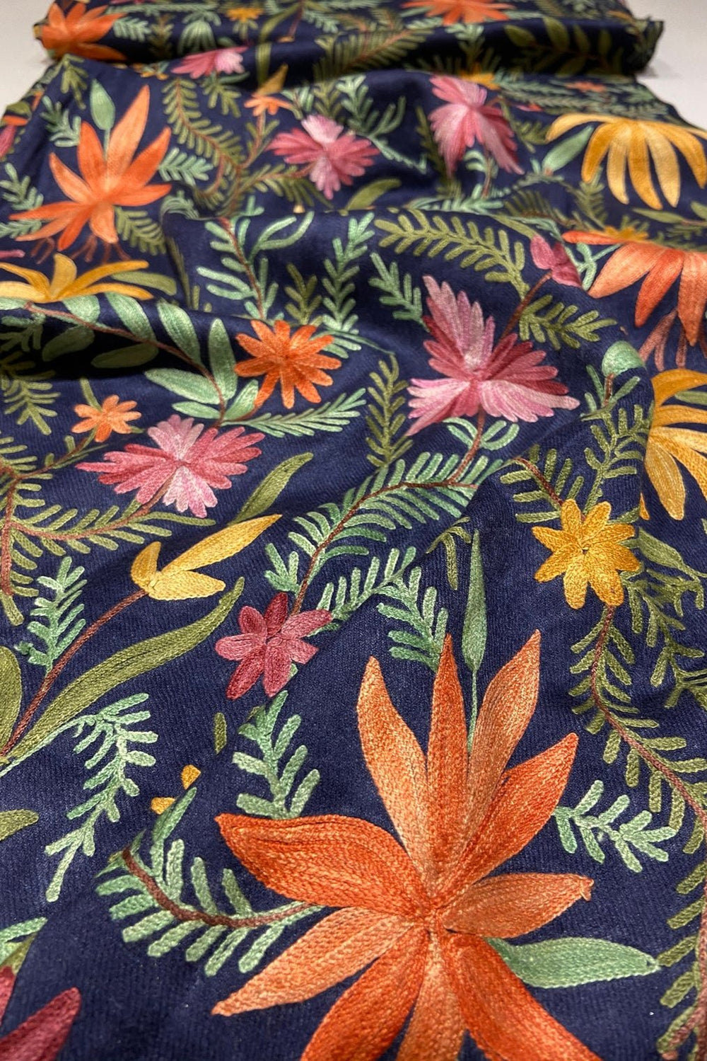Floral fabric with colorful flowers and leaves on a navy background