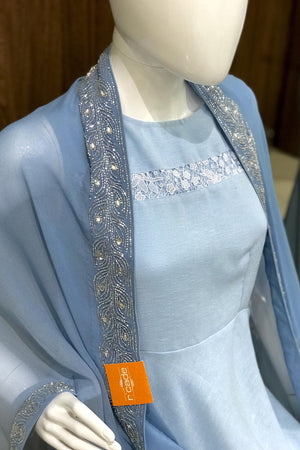 Mannequin wearing a light blue dress with a matching shawl