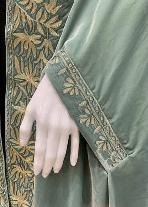 #MintGreen Green velvet garment with gold embroidery on a black background