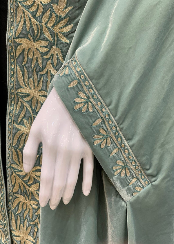 #MintGreen Green velvet garment with gold embroidery on a black background