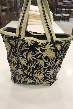 Black floral-patterned tote bag on a white surface