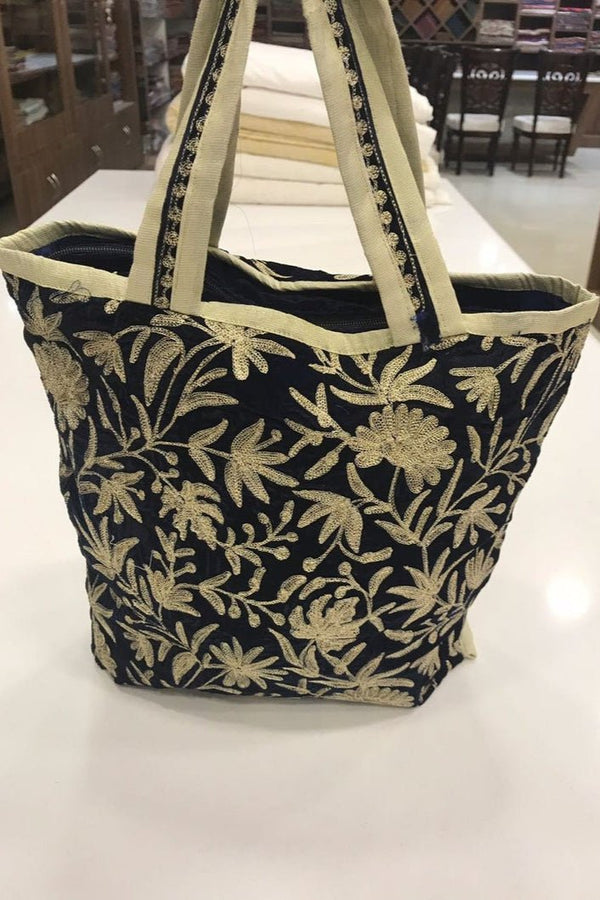 Black floral-patterned tote bag on a white surface
