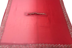 Red fabric with silver work border on a white background