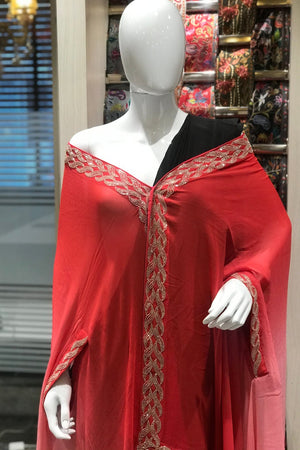 Red dress with gold embroidery on a mannequin in a store setting