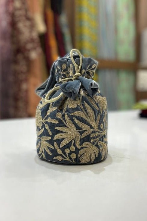 #Gray Decorative fabric pouch with floral patterns on a white surface