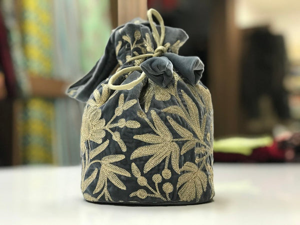 #Gray  Decorative drawstring bag with floral patterns on a blurred background