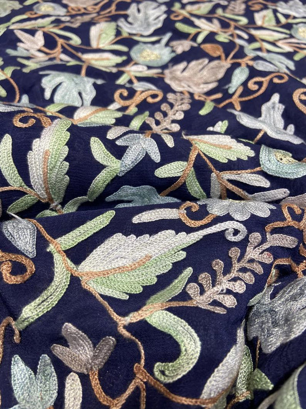 Embroidered fabric with floral patterns on a dark blue background