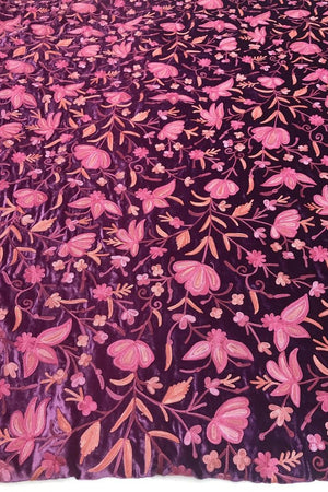 Floral patterned fabric with pink flowers on a dark background