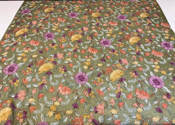 Floral fabric with colorful flowers on a green background